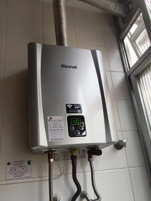 Aquecedor a gás Rinnai REU E-21 digital prata instalado pela Configás, com chaminé até a janela